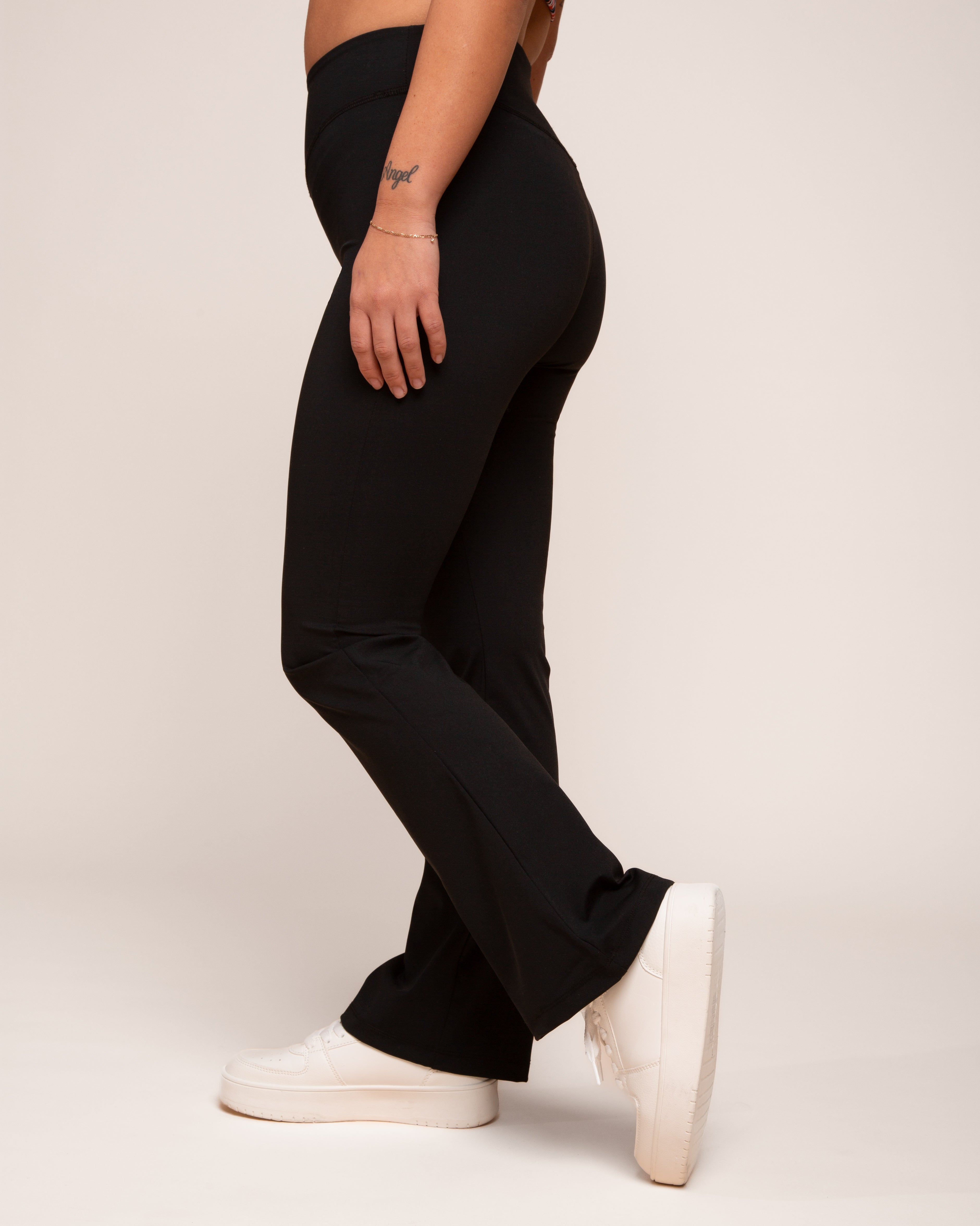 a person wearing black pants and white shoes