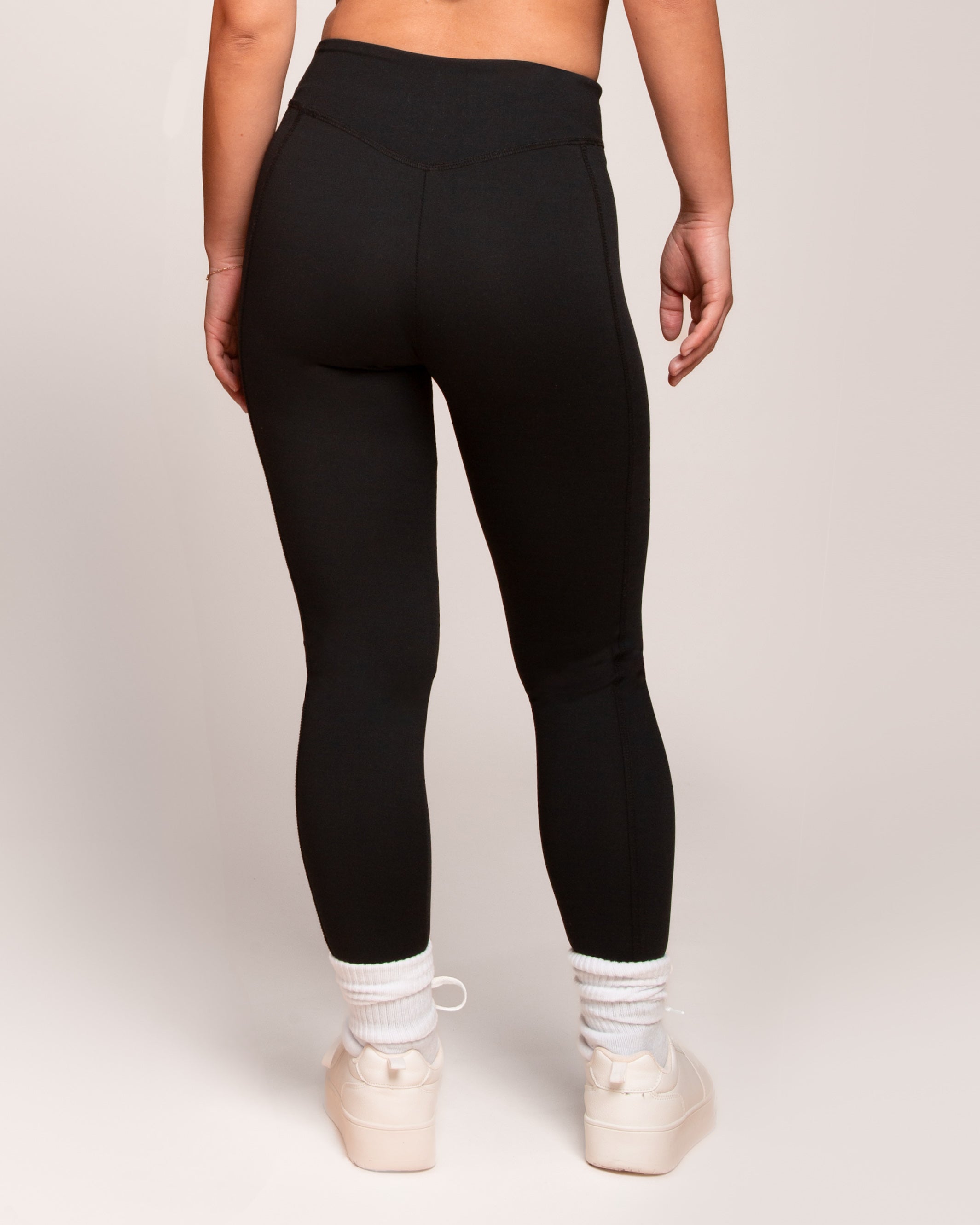 a person wearing black pants and white socks