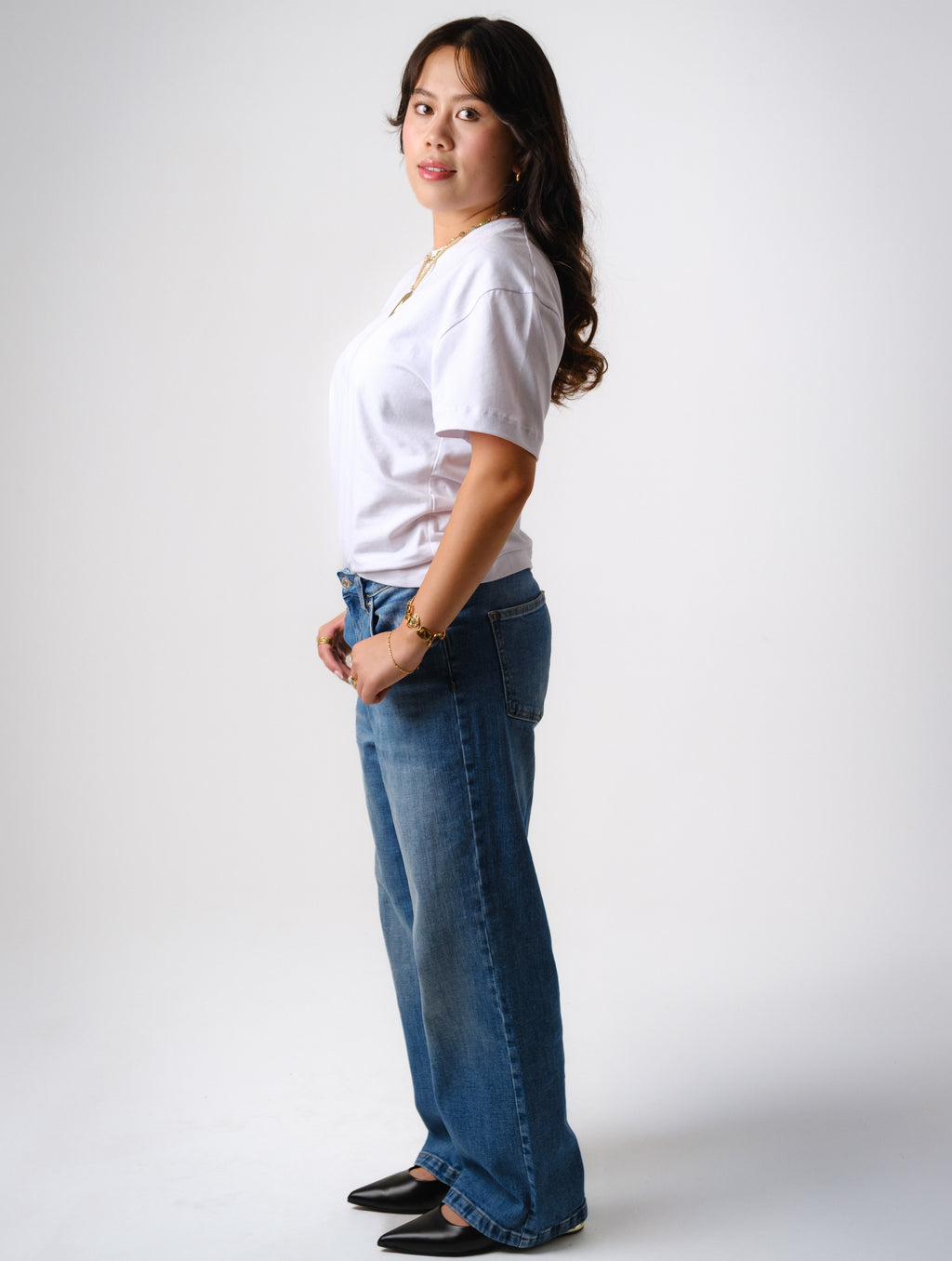 a woman in a white shirt and jeans