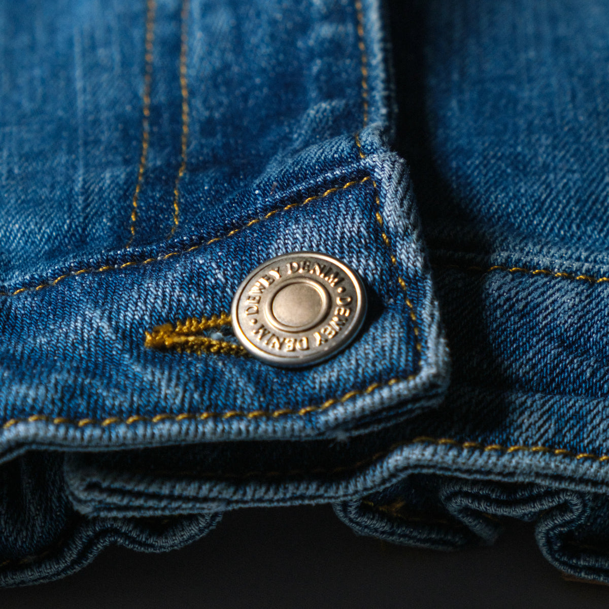 a close up of a button on a blue jean