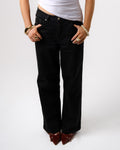 a woman wearing black pants and a white shirt