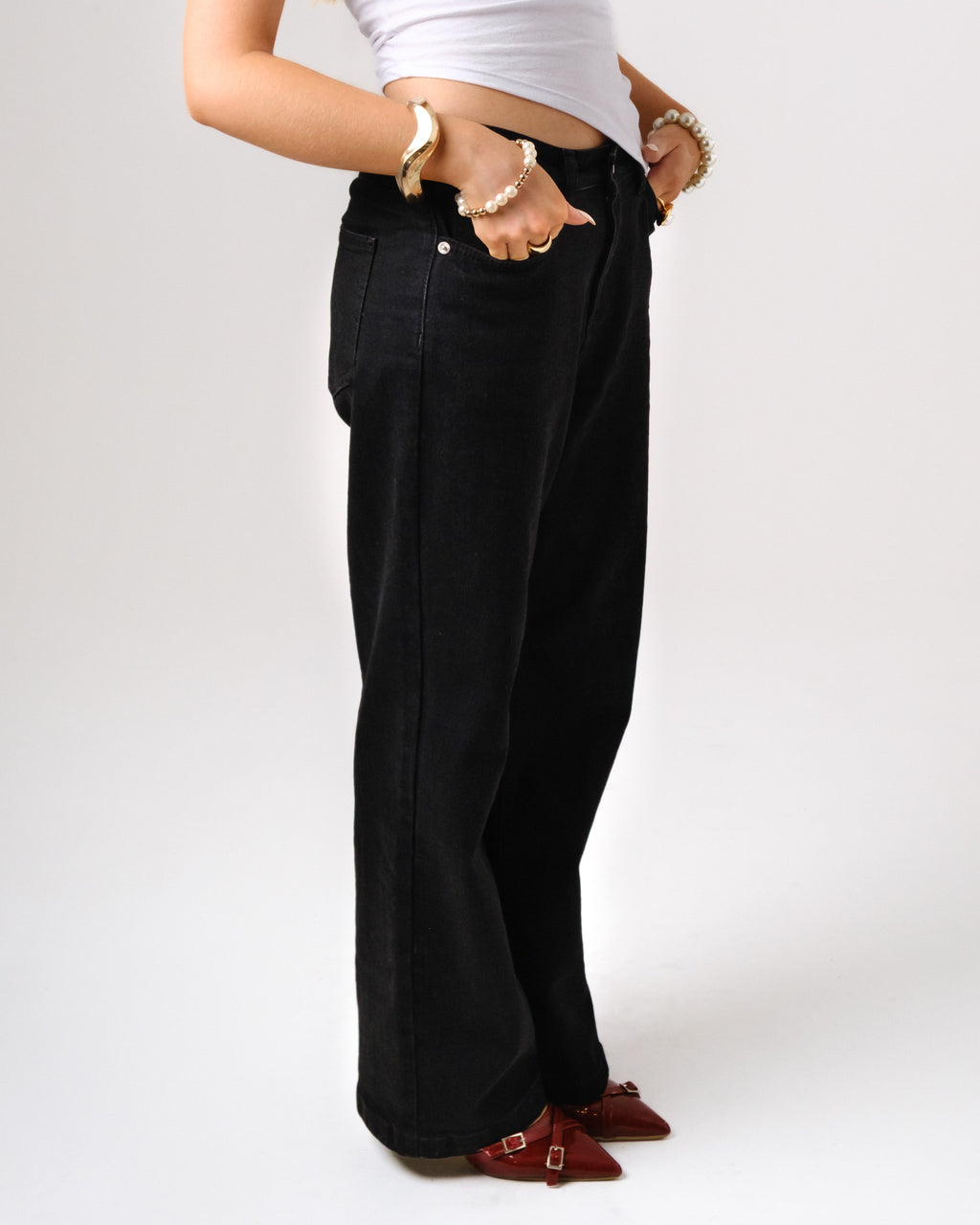 a woman wearing black pants and a white shirt