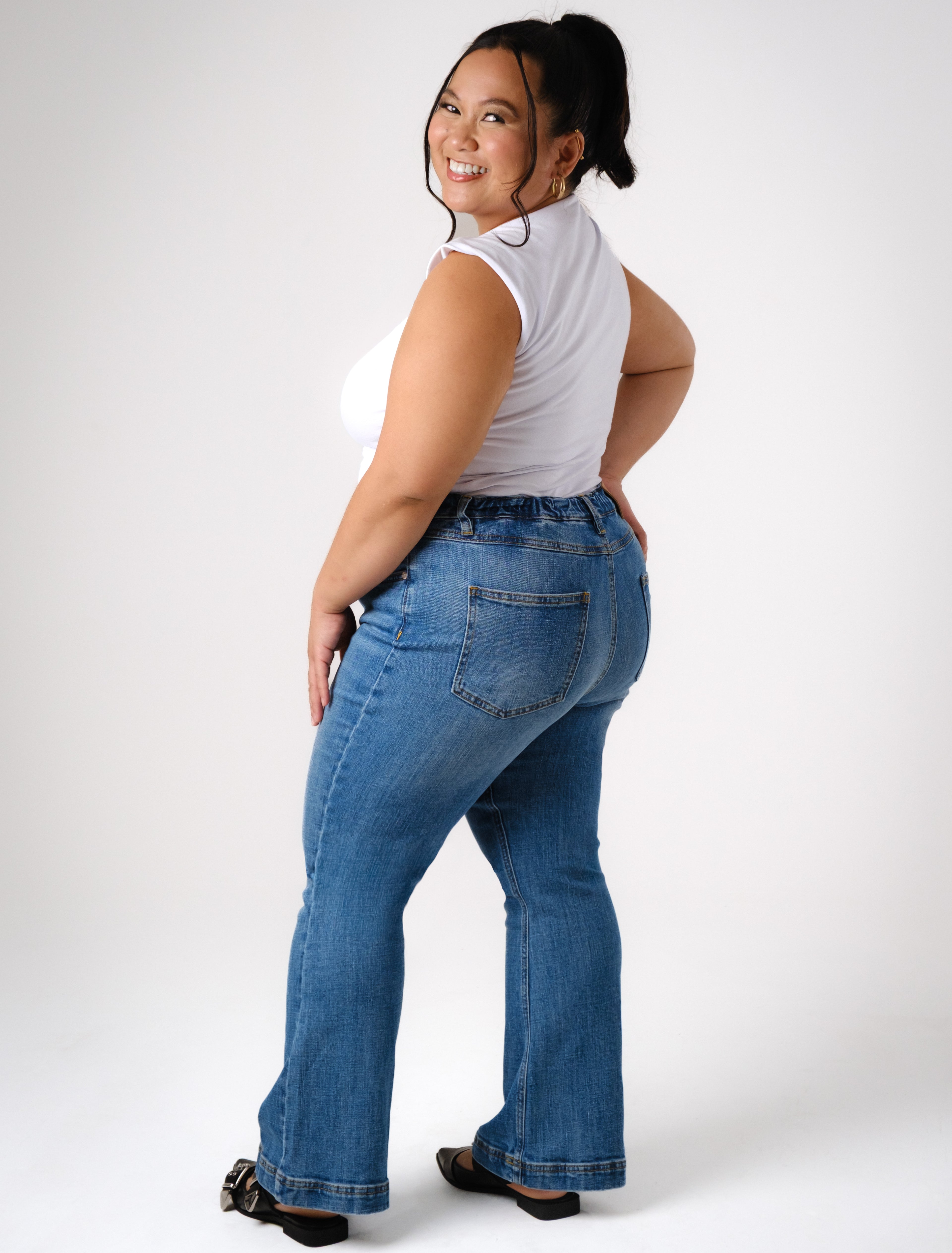 a woman in jeans and a white shirt
