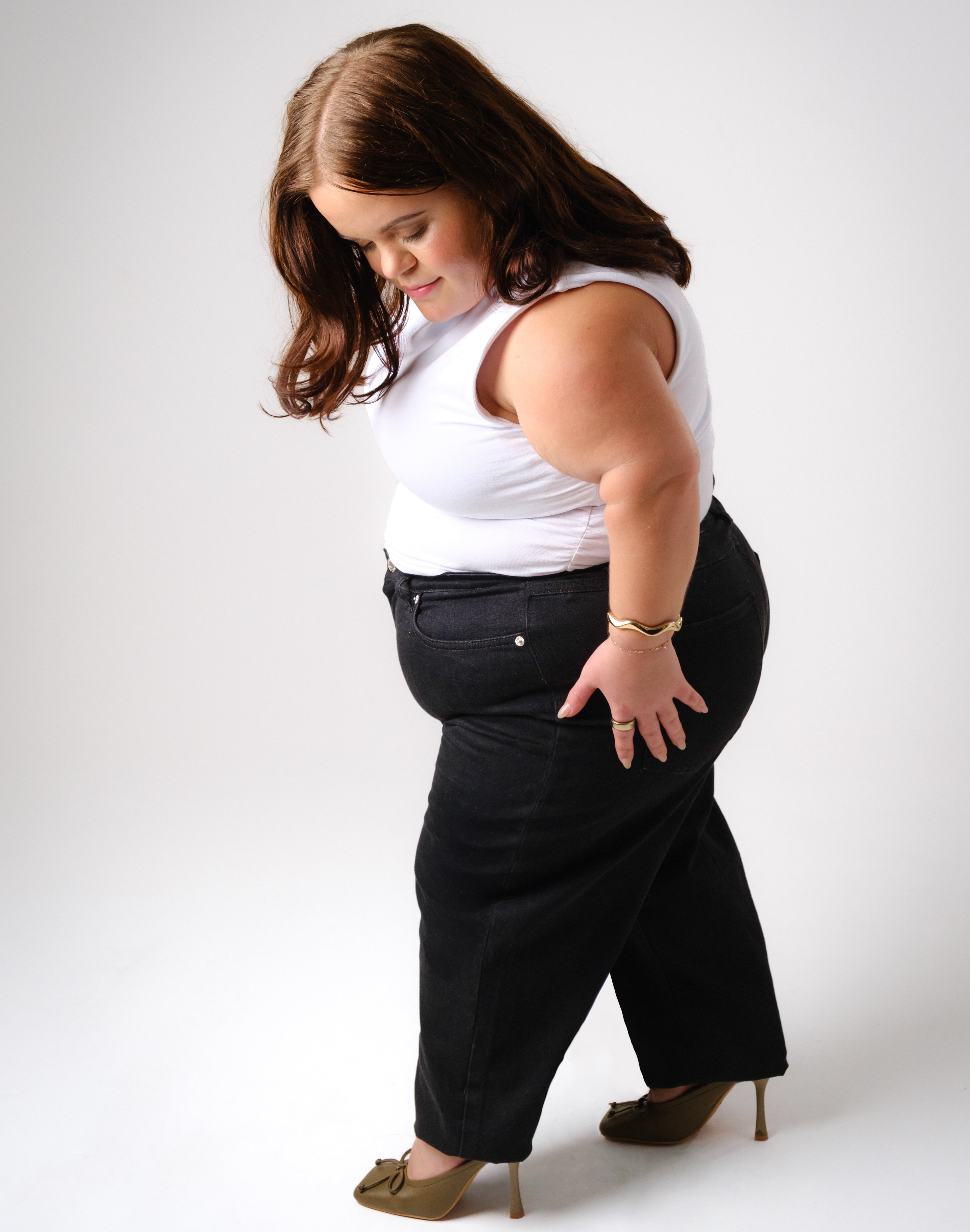 a woman in a white shirt and black pants