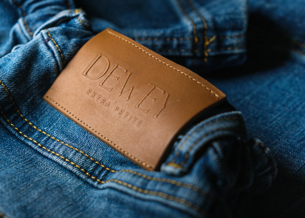 a brown leather tag in a blue jeans pocket
