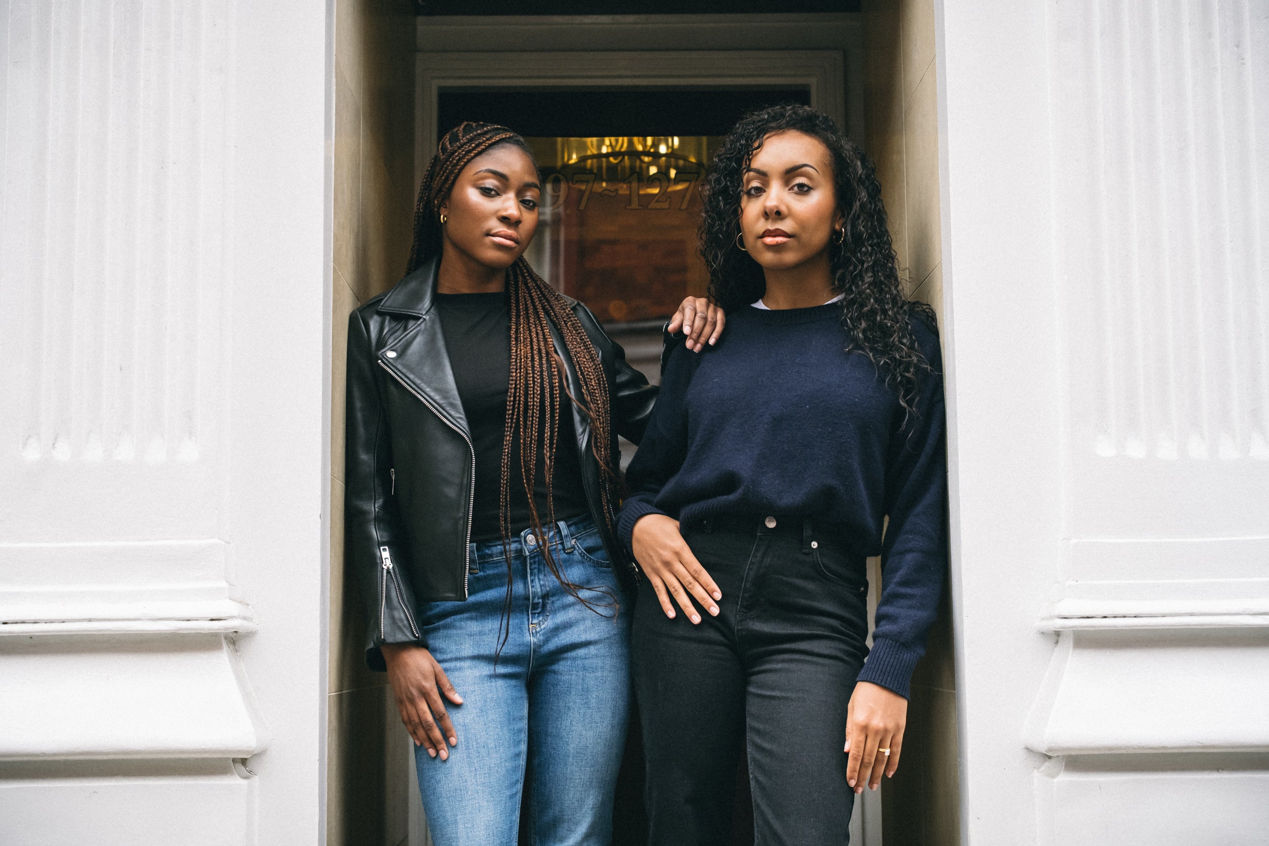 two women standing in a doorway