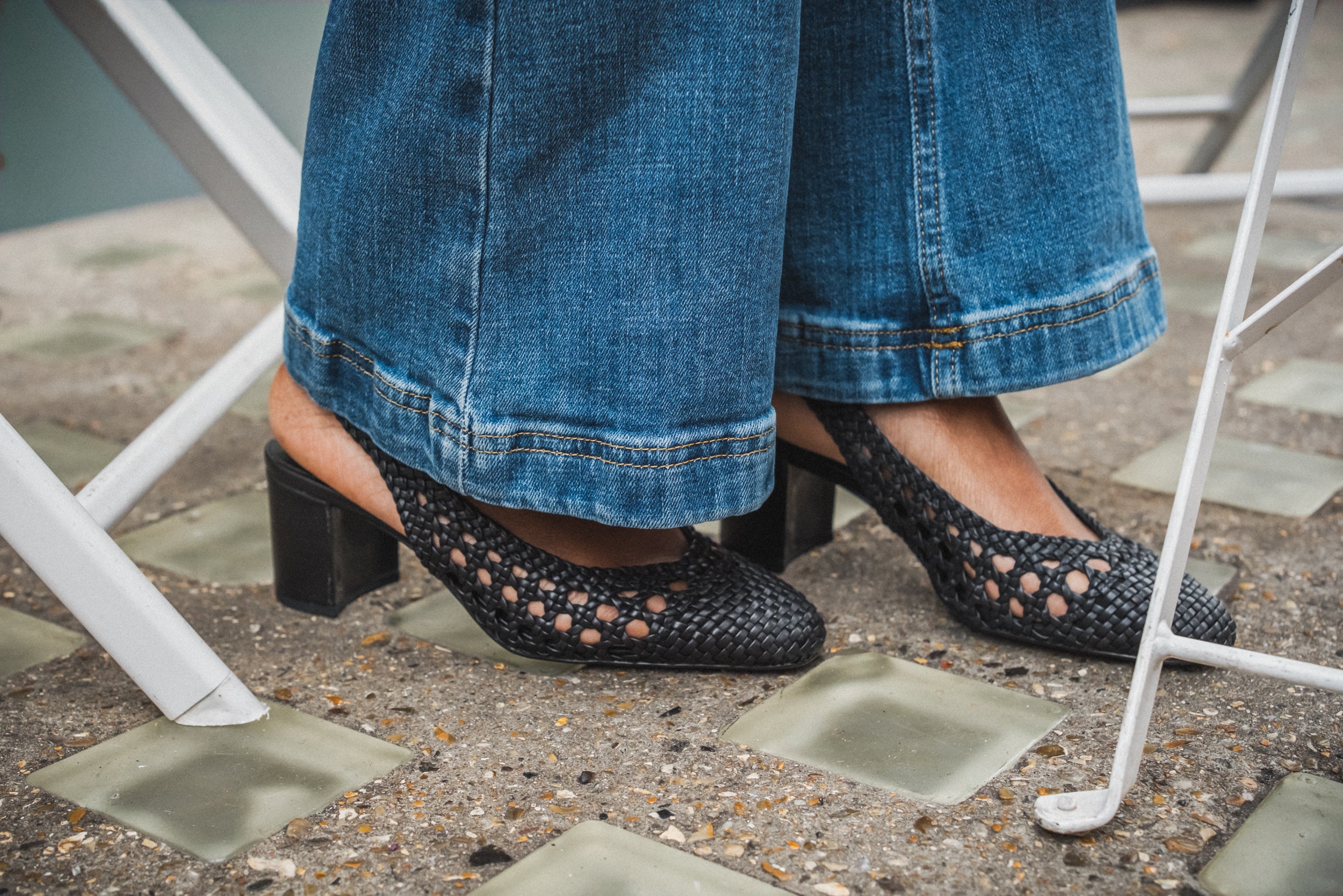 a pair of legs wearing black shoes