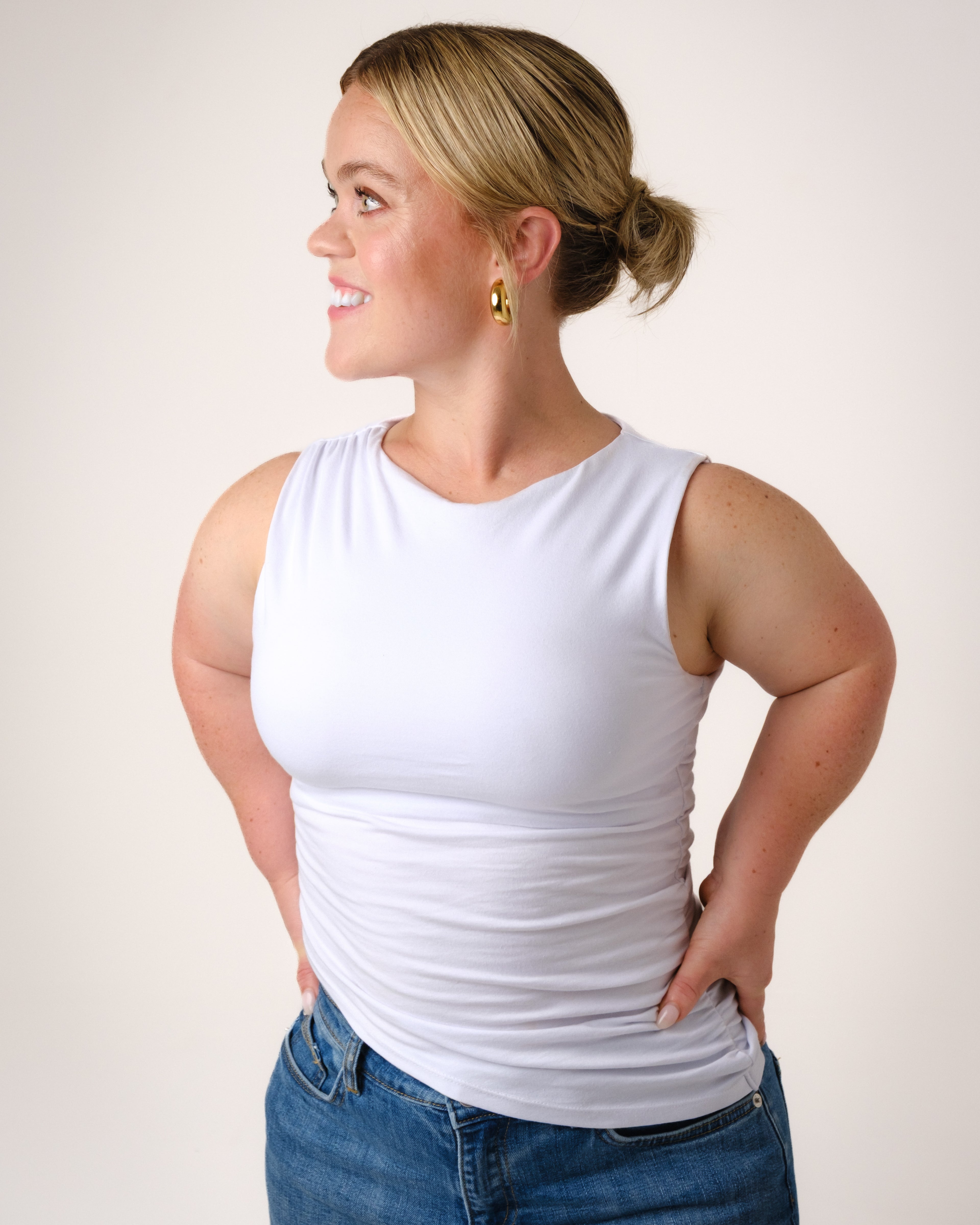 a woman in a white tank top