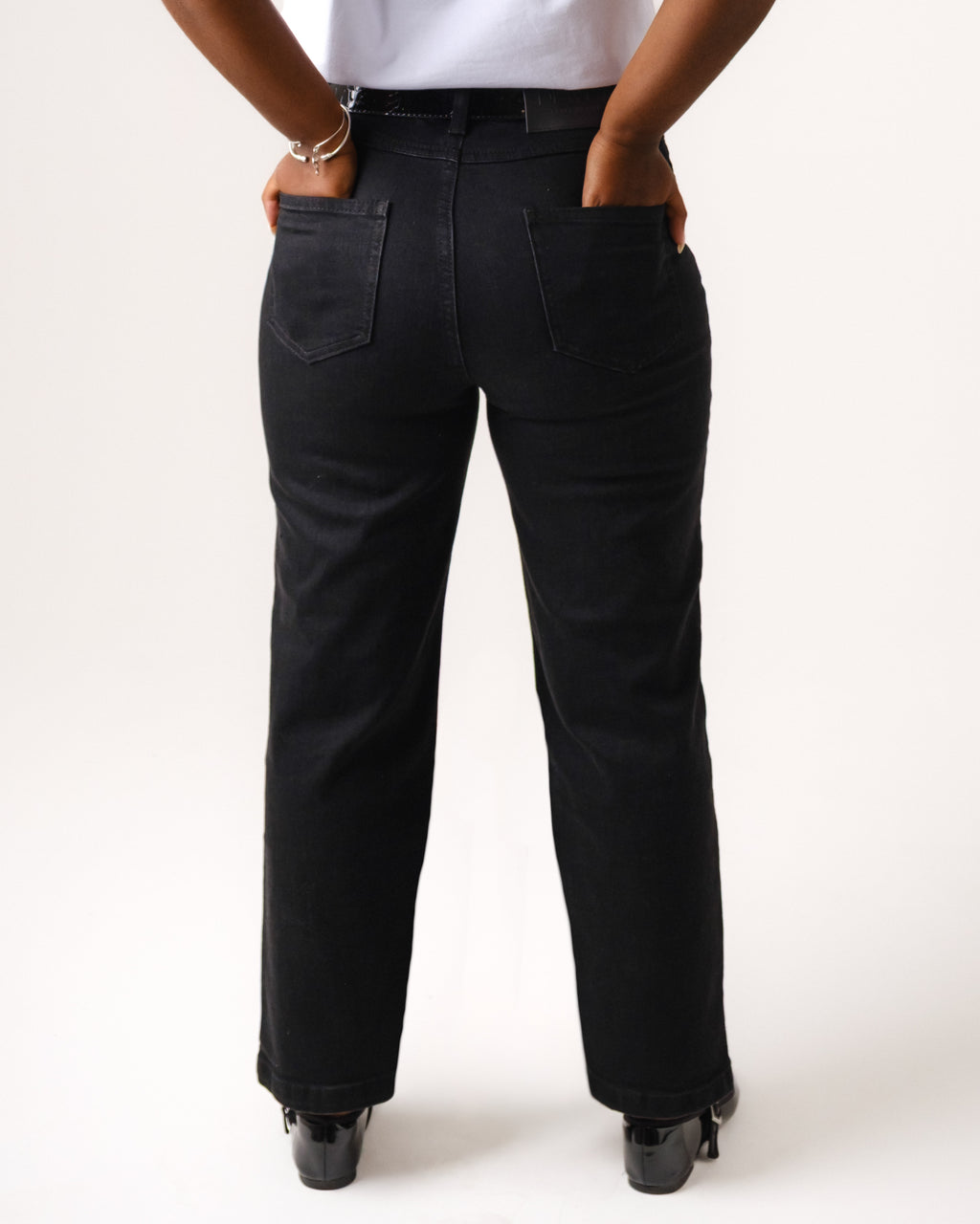 a person's back with their hands in their pockets