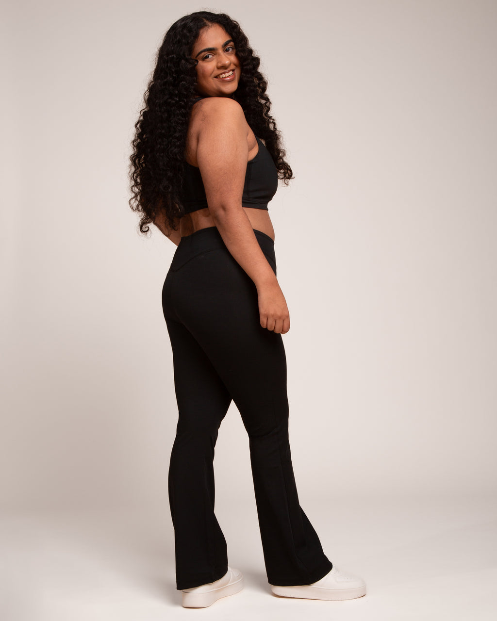 a woman in black pants and top